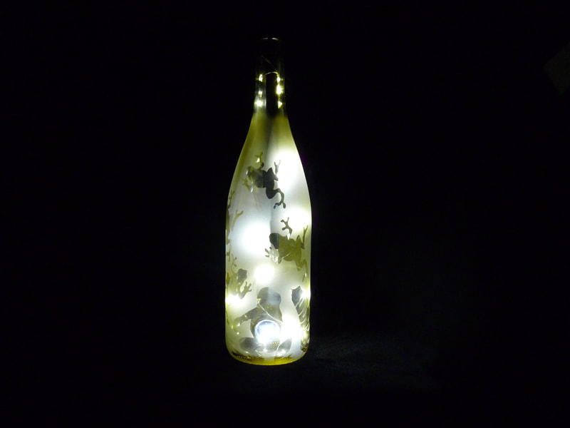Frogs on yellow wine bottle